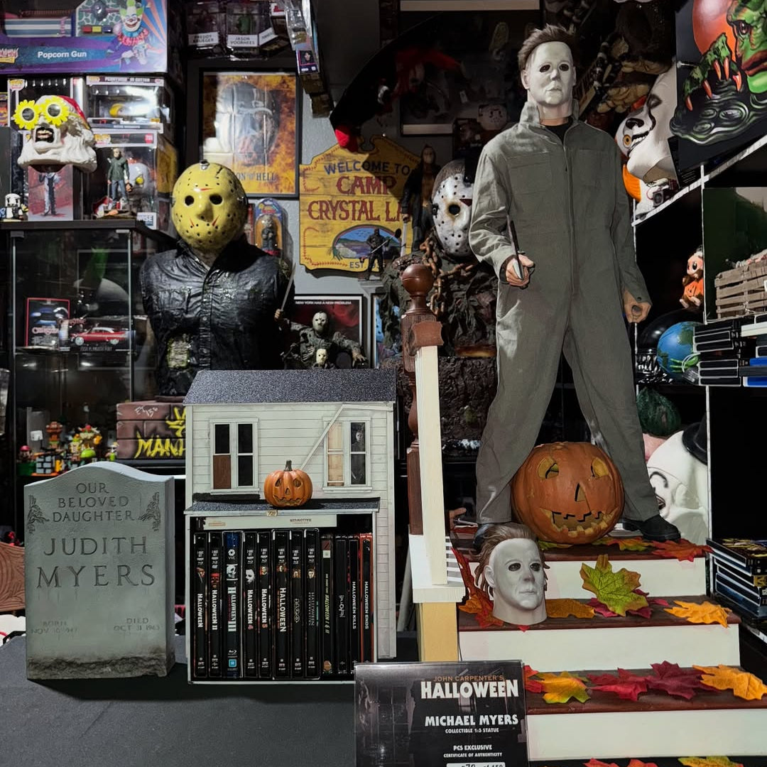 Display of Halloween-themed figures and decorations, including a Michael Myers figure, in a store setting.